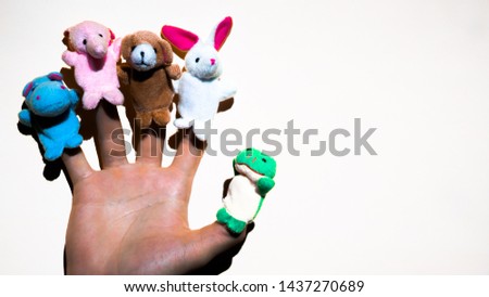 Puppet theater of doll  animals. Hand wearing finger puppets: elephant, frog, dog, rabbit, hippo,bear. animal finger puppets show.