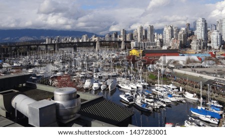Canada, BC, Vancouver city panorama with Burrard Bridge and Granville Island harbor at sunny day.