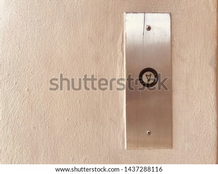 close up elevator button on building wall next to elevator