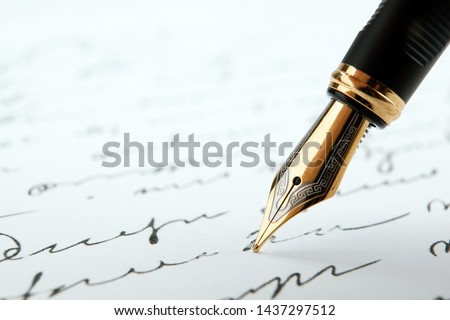 fountain pen on paper with ink text on a white background closeup Royalty-Free Stock Photo #1437297512
