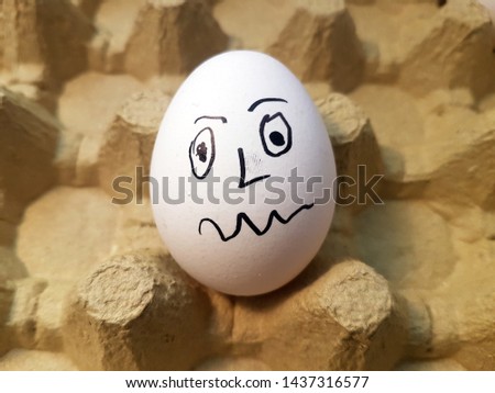  Drawing face emoji on white egg