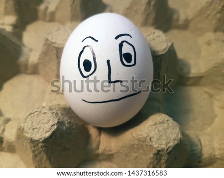  Drawing face emoji on white egg