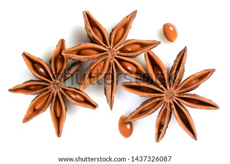 Star anise. Three star anise fruits with two seeds. Macro close-up Isolated on white background with shadow, top view of chinese badiane spice or Illicium verum. Royalty-Free Stock Photo #1437326087