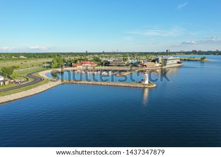 Evening drone photo of the lighthouse and marina at Lake Hefner with the Oklahoma City skyline on the horizon
