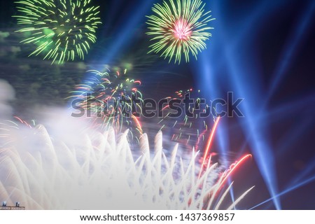 Colored firework background with free space for text. Colorful fireworks at night light up the sky with dazzling display.