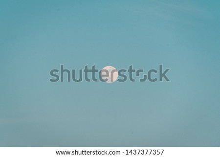 A full moon with blue sky