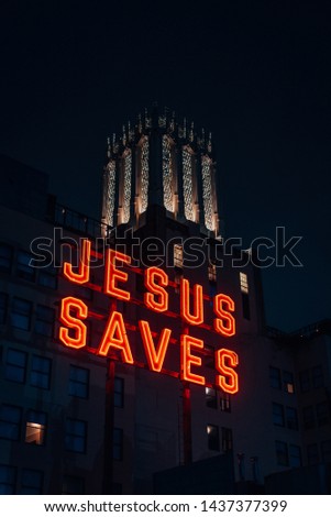 Jesus Saves sign at night, in downtown Los Angeles, California