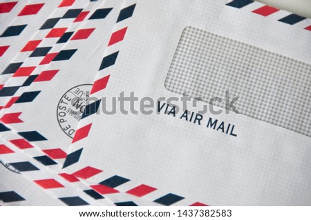 Stack of traditional envelopes for sending letters by airplane with text