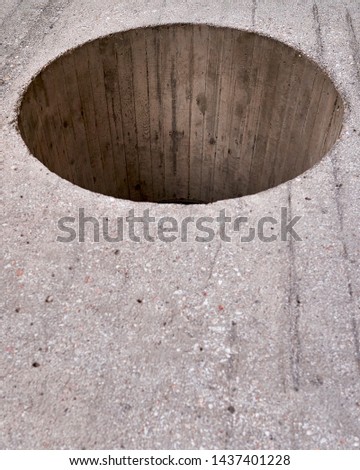 huge window circular hole on simple plain concrete wall