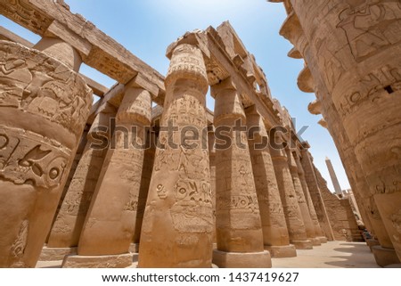 Pillars with hieroglyphs in Great Hypostyle Hall at the Temples of Karnak (ancient Thebes), Luxor, Egypt Royalty-Free Stock Photo #1437419627