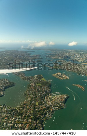 A aerial shot of Sydney Harbor from an airplane.