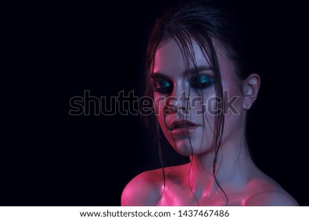 Color fashion woman neon lights. Rainbow make-up, portrait of a girl isolated on a bright background. Colorful color scheme. Glitter Vivid neon makeup