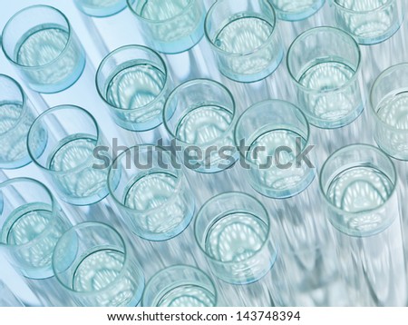 Upper view, macro of transparent glass labware with floating colorless solution