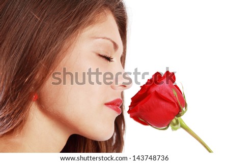Close up of woman sniffing red rose with closed eyes isolated on white background.