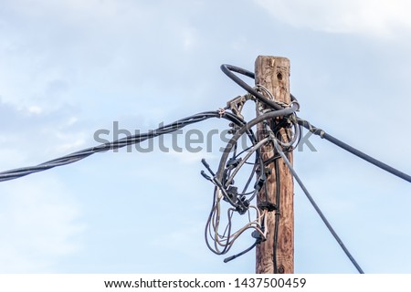 Cables on a wooden pole next to the private resorts in leptokaria, Greece