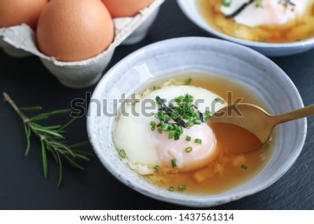 Close up of traditional Japanese hot spring egg (Onsen Tamago) in a bowl with spoon to eating, it's a traditional method of boiling eggs in the hot springs of Japan