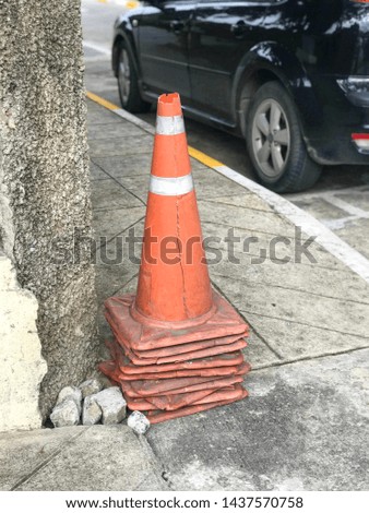 Orange traffic cone used to tell traffic signs