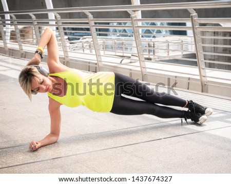Portrait of fit and sporty caucasian woman exercise in city