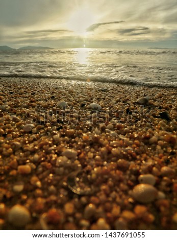 Pebbles on a beach during sunrise 