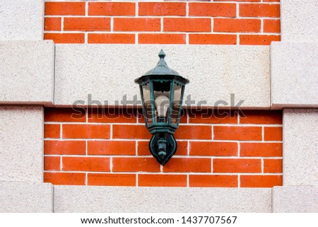 Beautiful old wall lamp at red bricks wall