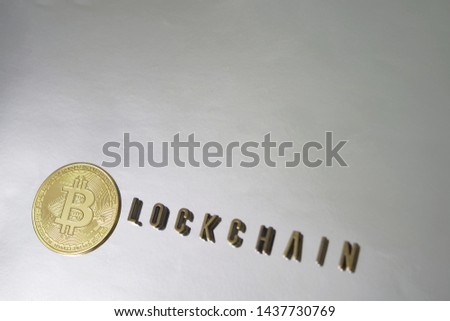 Bitcoin and blockchain metal letters on silver background 