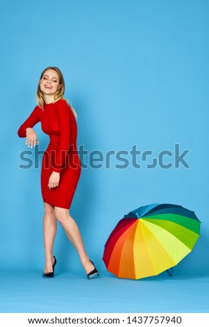 woman in a red dress with a multi-colored umbrella                               