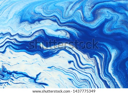 photography of abstract marbleized effect background. Blue and white creative colors. Beautiful paint.