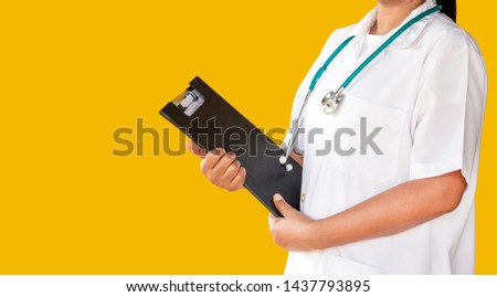 doctor with lab coat on yellow background holding a clipboard. 
