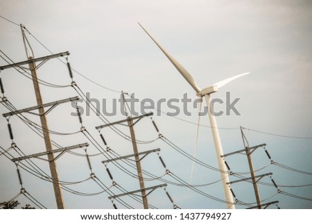 Wind turbine farm power generator in beautiful nature landscape for production of renewable green energy is friendly industry to environment.