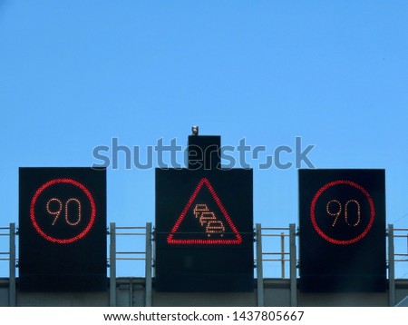 Electronic LED road signs "Speed limit 90 km/h" and congestion / traffic jam warning in the middle