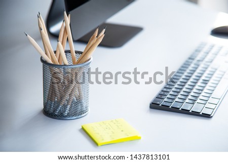 Modern working space with notepad, keyboard, computer or notbook  and pencils on white table in modern office, the working accessories for business man or designer