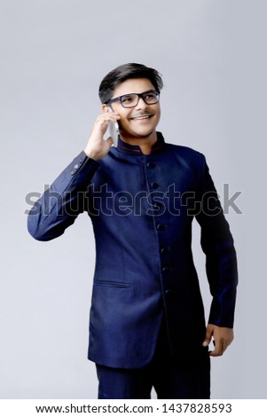 young asian business man talking on mobile phone, isolated on white background.
