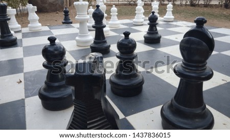 Life size chess board with different pieces like pawn bishops knights and king