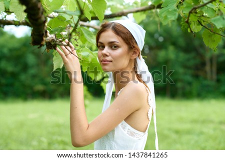 woman in white scarf tree cottage nature