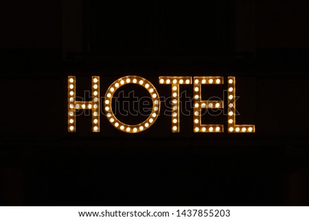 An old light bulb sign with the word "Hotel" placed over the entrance to a hotel in Malmö, Sweden.
