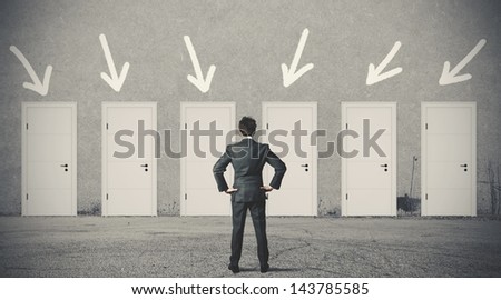 Concept of businessman choosing the right door Royalty-Free Stock Photo #143785585