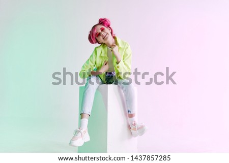 a woman in a green jacket is sitting on a fashion style plate