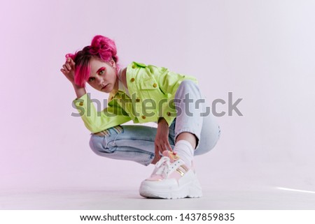 woman with pink hair crouched sneakers fashion style