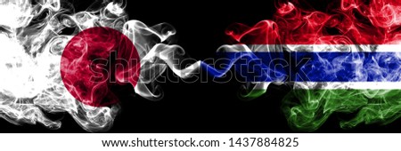 Japan vs Gambia, Gambian smoky mystic flags placed side by side. Thick colored silky smokes combination of Gambia, Gambian and Japanese flag