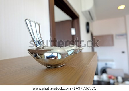Silver bird element for decorate living room in apartment. wallpaper, aircondotion, table dinning.