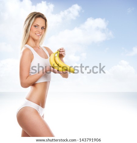 Beautiful woman with an exotic fruit over the heaven background