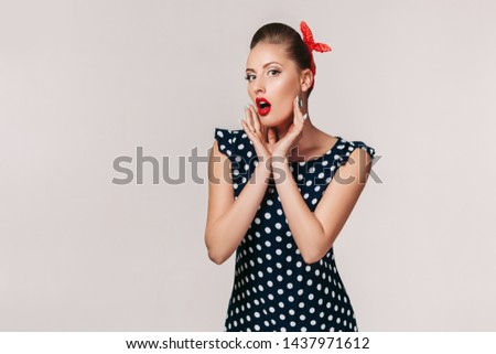 portrait of surprised pin up woman in polka dot dress. cute girl in retro style. copy space for text