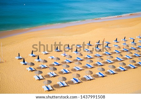 blurry picture of Atlantic coast beach in Albufeira, Portugal, beach chairs