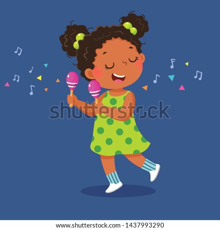 Cute little girl playing the maracas on blue background