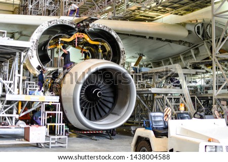 Jet engine remove from aircraft (airplane) for maintenance at aircraft hangar.Jet engine maintenance and change part by aircraft technician . Royalty-Free Stock Photo #1438004588
