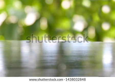 table with tree blur background.