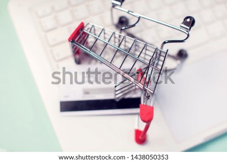 Laptop with shopping trolley. Online shopping and payment concept
