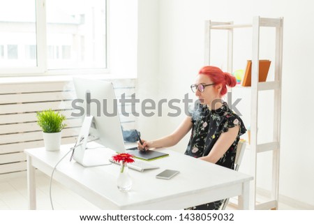 graphic designer concept - Female graphic designer working on computer while using graphic tablet at desk in the office and smoking a vape