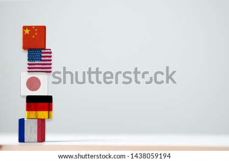 Print screen of flag on wooden cubic of top 5 the biggest economic countries include China USA Japan Germany and France. Bu