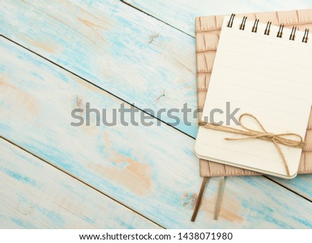 Notebook for notes on a blue wooden background